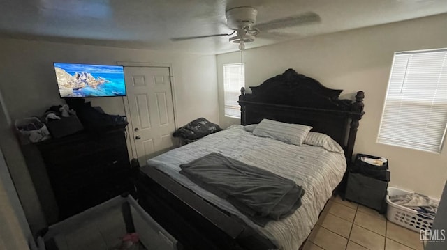 bedroom with ceiling fan and light tile patterned flooring