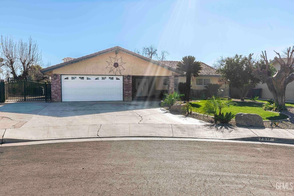 single story home featuring a front yard and a garage