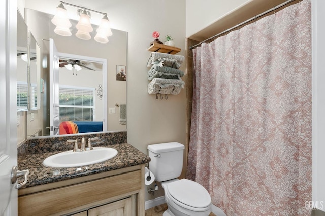 bathroom featuring toilet, a ceiling fan, and vanity