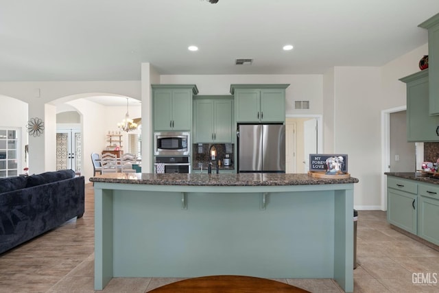 kitchen with visible vents, appliances with stainless steel finishes, and green cabinets