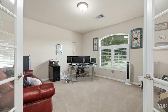 office featuring baseboards, visible vents, french doors, and light colored carpet