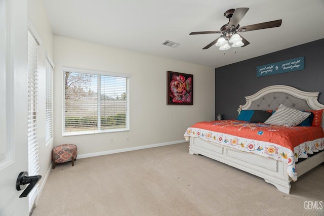 bedroom with a ceiling fan, visible vents, baseboards, and carpet flooring