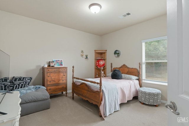 bedroom with carpet, visible vents, and baseboards