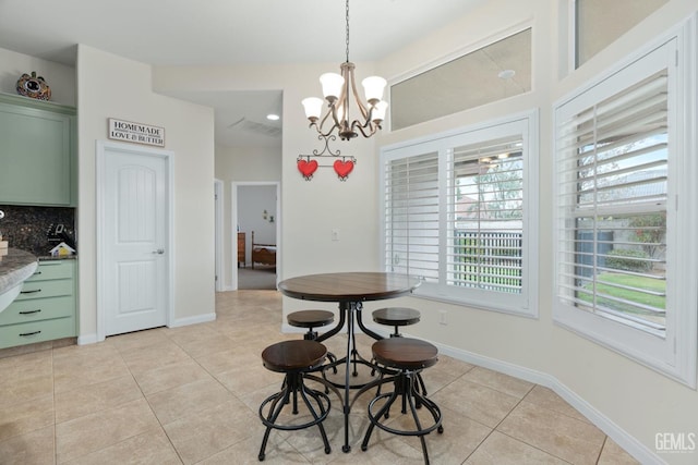 dining space featuring an inviting chandelier, visible vents, baseboards, and light tile patterned floors