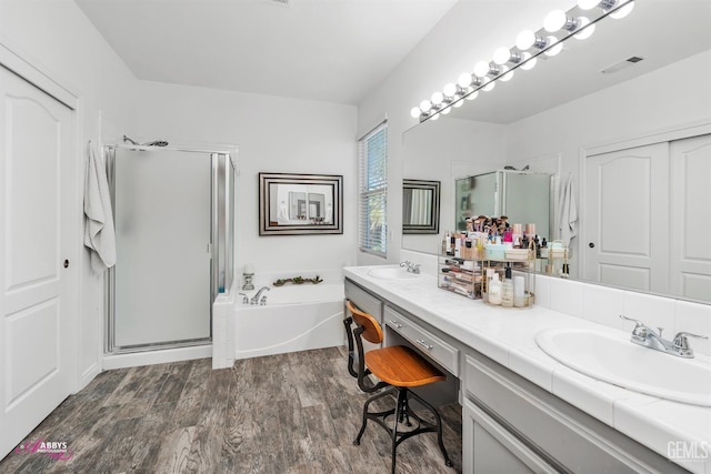 11820 Crescent Creek Ct, Bakersfield, CA 93311 - bathroom with a shower stall, double vanity, a bath, and wood finished floors