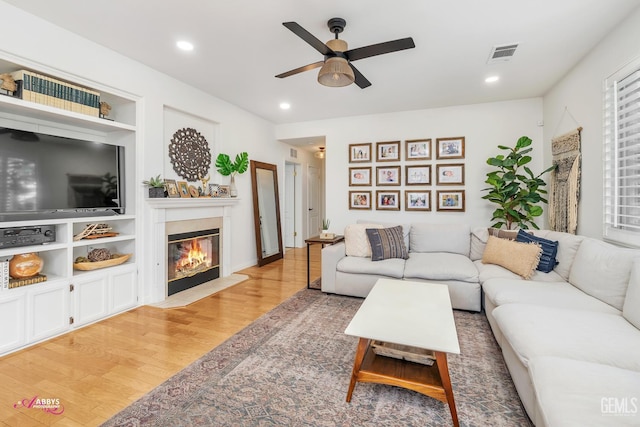 11820 Crescent Creek Ct, Bakersfield, CA 93311 - living room with ceiling fan, wood finished floors, a fireplace with flush hearth, plenty of natural light, and recessed lighting