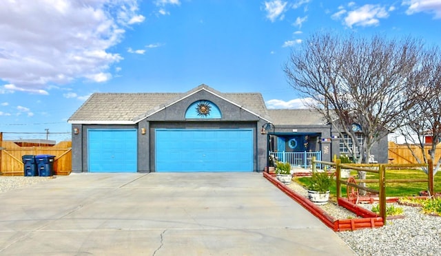 ranch-style house with concrete driveway, a tiled roof, an attached garage, fence, and stucco siding