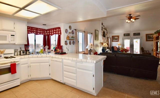 kitchen featuring french doors, open floor plan, white cabinets, white appliances, and a peninsula