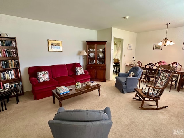 carpeted living room featuring a notable chandelier