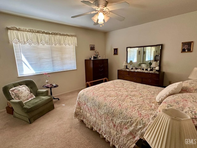 bedroom with a ceiling fan, carpet, and baseboards