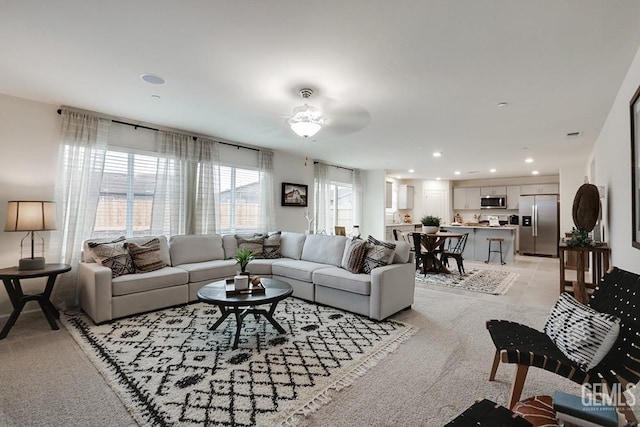 carpeted living room featuring ceiling fan