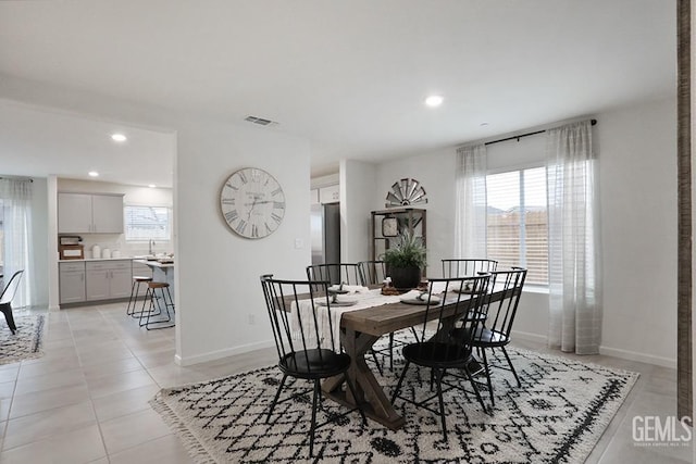 dining area with sink and light tile patterned floors