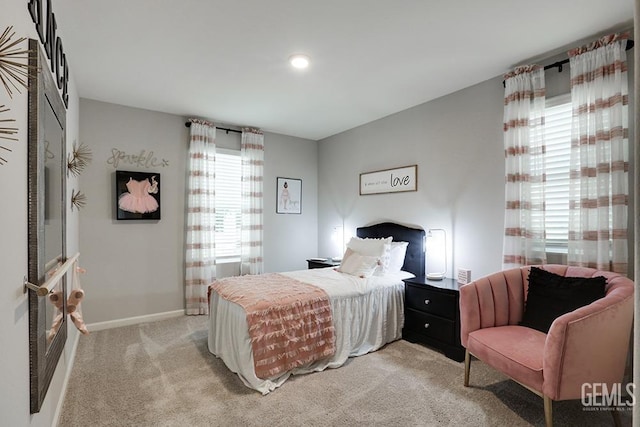 carpeted bedroom with multiple windows