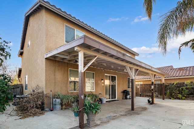 rear view of property featuring a patio