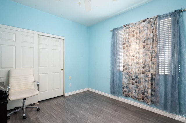 unfurnished office featuring dark hardwood / wood-style floors and ceiling fan