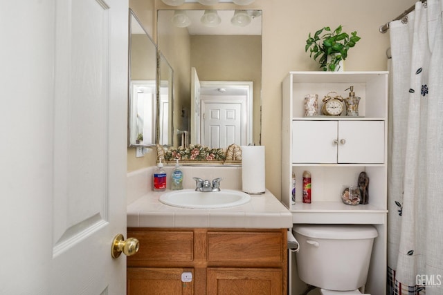 bathroom with toilet and vanity