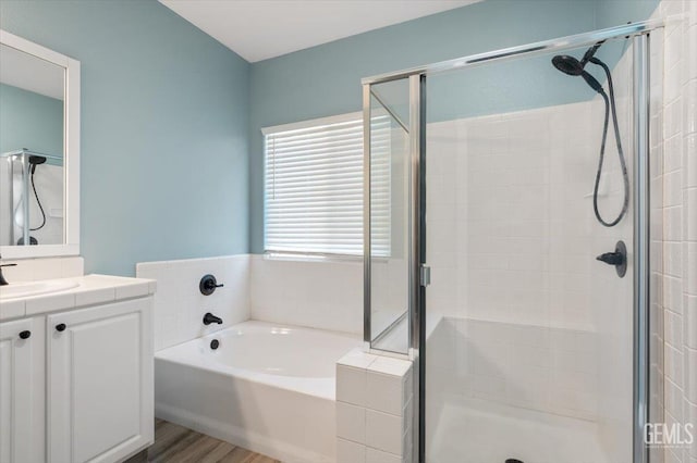 11311 Mezzadro Ave, Bakersfield, CA 93312 - bathroom with vanity, a bath, a shower stall, and wood finished floors