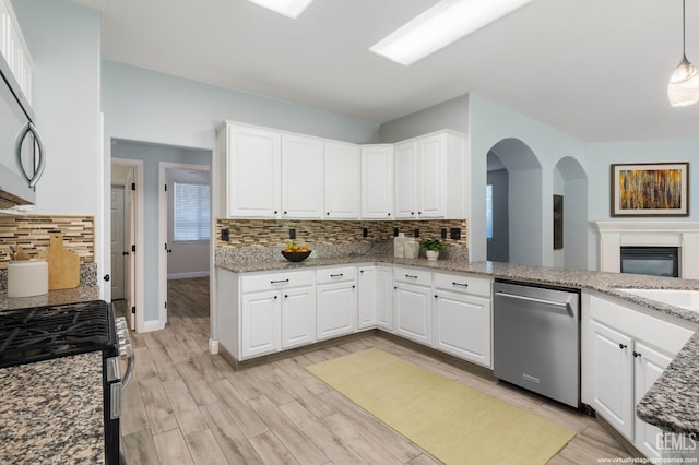 11311 Mezzadro Ave, Bakersfield, CA 93312 - kitchen with appliances with stainless steel finishes, decorative backsplash, white cabinets, light wood-style flooring, and light stone counters