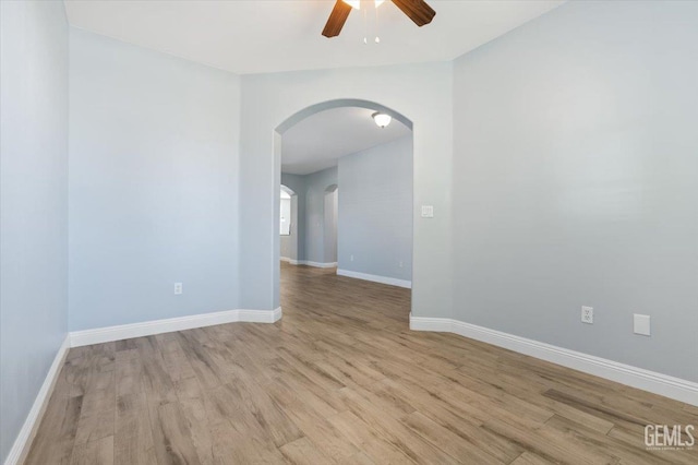 11311 Mezzadro Ave, Bakersfield, CA 93312 - empty room with arched walkways, light wood-style flooring, and a ceiling fan