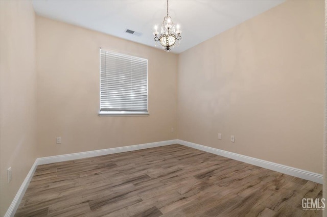 11311 Mezzadro Ave, Bakersfield, CA 93312 - empty room featuring a chandelier and wood finished floors