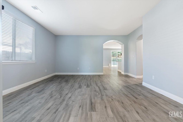 11311 Mezzadro Ave, Bakersfield, CA 93312 - empty room featuring arched walkways and wood finished floors