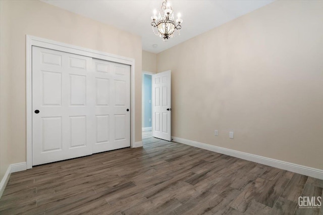 11311 Mezzadro Ave, Bakersfield, CA 93312 - unfurnished bedroom with a chandelier, wood finished floors, and a closet