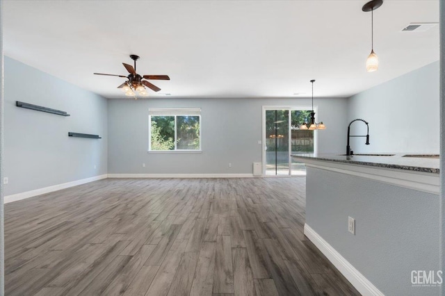 11311 Mezzadro Ave, Bakersfield, CA 93312 - unfurnished living room with plenty of natural light, wood finished floors, a ceiling fan, and a chandelier