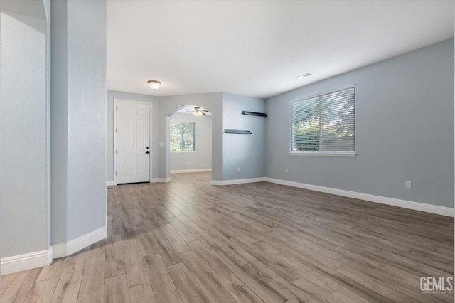 11311 Mezzadro Ave, Bakersfield, CA 93312 - empty room featuring wood finished floors and arched walkways