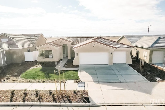 mediterranean / spanish house featuring a front yard and a garage