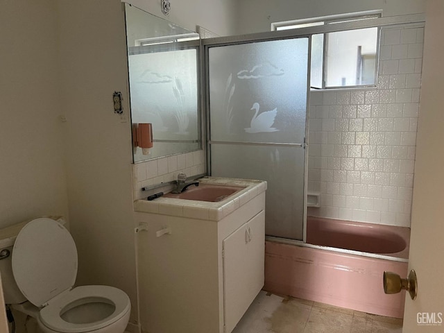 full bathroom featuring backsplash, shower / bath combination with glass door, tile patterned flooring, vanity, and toilet