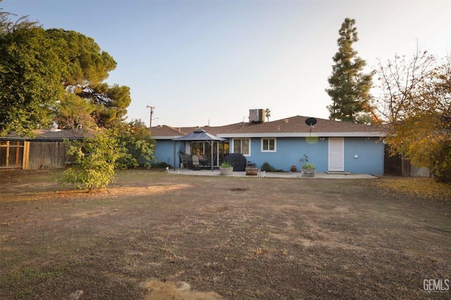 view of front of house featuring a gazebo, a patio area, and central air condition unit