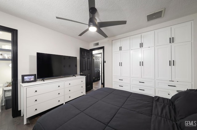 705 Stephens Dr, Bakersfield, CA 93304 - bedroom with a textured ceiling, dark wood-style floors, ceiling fan, and a closet