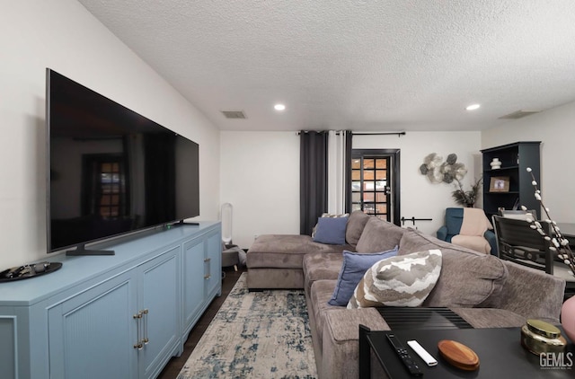 705 Stephens Dr, Bakersfield, CA 93304 - living room with a textured ceiling, recessed lighting, and dark wood-style flooring