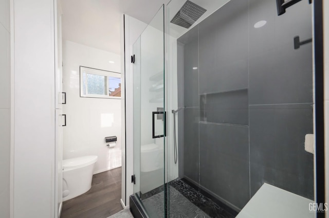 705 Stephens Dr, Bakersfield, CA 93304 - bathroom with toilet, a stall shower, and wood finished floors