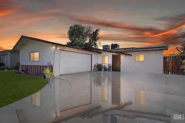 705 Stephens Dr, Bakersfield, CA 93304 - view of front of property with an attached garage, concrete driveway, and stucco siding