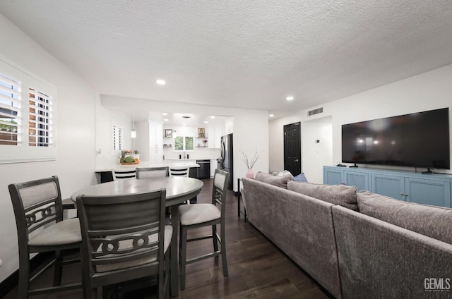 705 Stephens Dr, Bakersfield, CA 93304 - living room with dark wood-type flooring, recessed lighting, and a textured ceiling