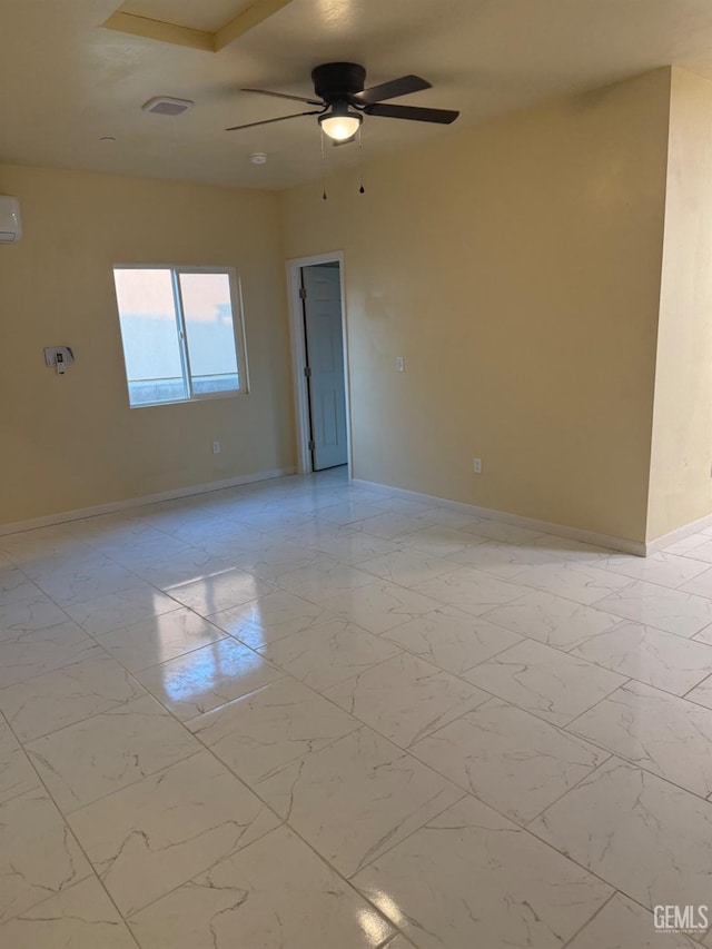 unfurnished room with ceiling fan and an AC wall unit