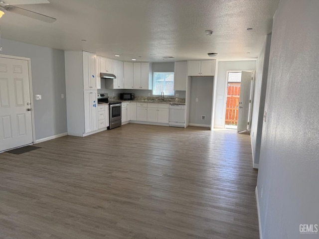 kitchen with white dishwasher, white cabinets, electric range, and sink