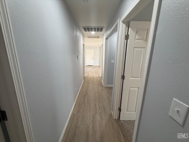 hallway with light hardwood / wood-style flooring