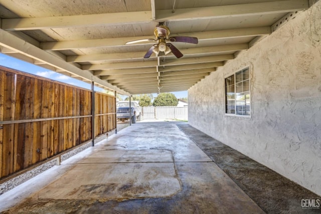 view of patio / terrace with a carport and ceiling fan