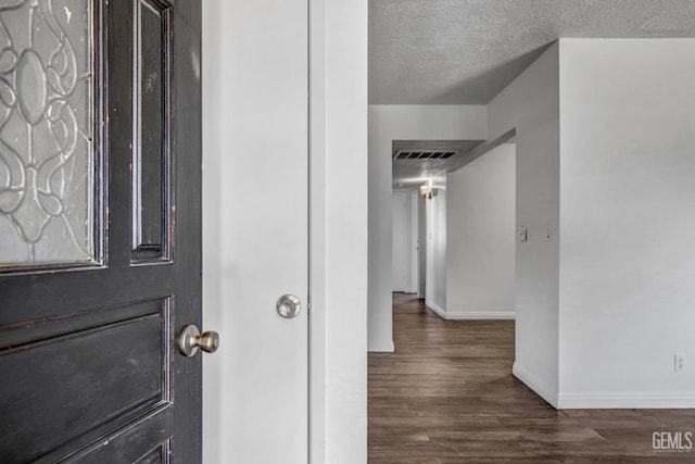 entryway featuring dark hardwood / wood-style floors and a textured ceiling