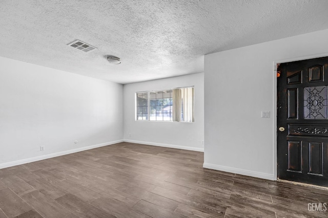 interior space with dark hardwood / wood-style flooring and a textured ceiling