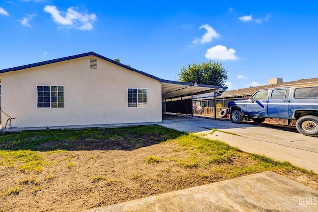 view of side of home featuring a carport