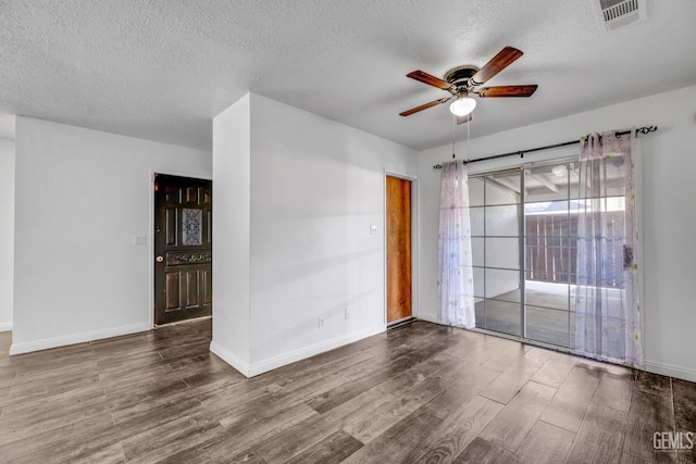 empty room featuring wood-type flooring, a textured ceiling, and ceiling fan