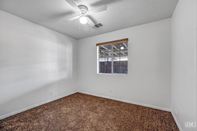 empty room with a textured ceiling, carpet floors, and ceiling fan