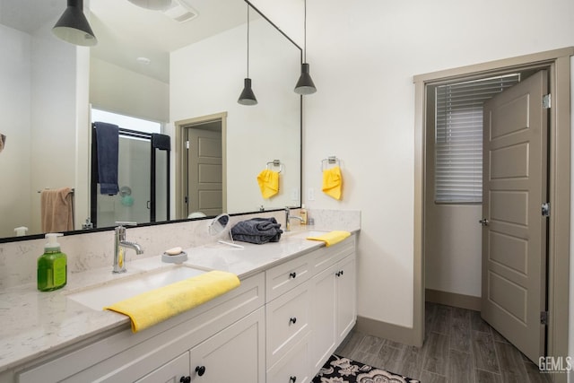 6622 Sycamore Wood Ln, Bakersfield, CA 93313 - bathroom featuring double vanity, a shower stall, and wood finished floors