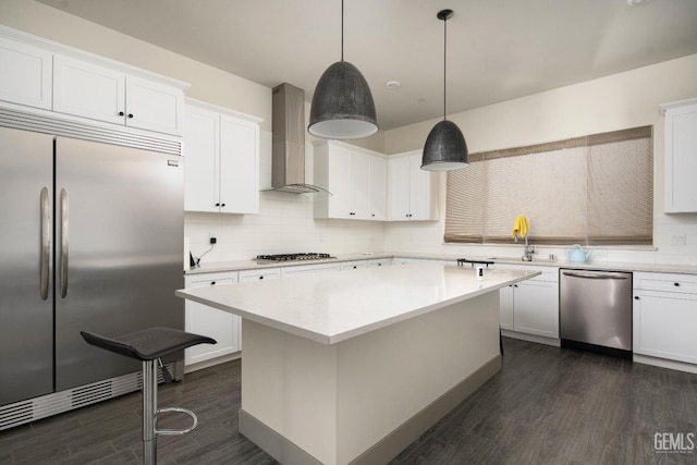 6622 Sycamore Wood Ln, Bakersfield, CA 93313 - kitchen featuring appliances with stainless steel finishes, wall chimney exhaust hood, dark wood-type flooring, and backsplash