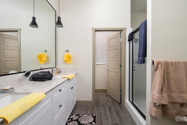 6622 Sycamore Wood Ln, Bakersfield, CA 93313 - full bath featuring wood finished floors, a shower stall, and double vanity
