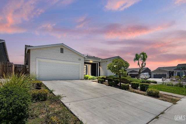6622 Sycamore Wood Ln, Bakersfield, CA 93313 - view of front of home featuring concrete driveway, an attached garage, and brick siding