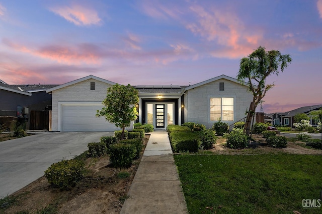 6622 Sycamore Wood Ln, Bakersfield, CA 93313 - ranch-style house with a garage, solar panels, concrete driveway, a front yard, and french doors